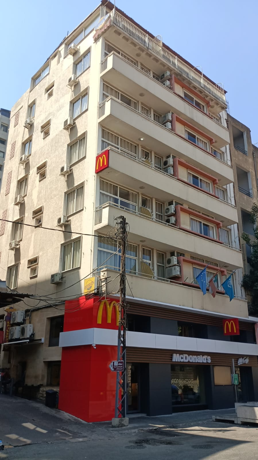 The University Hotel building on its corner above Bliss Street, with the McDonald’s at street level